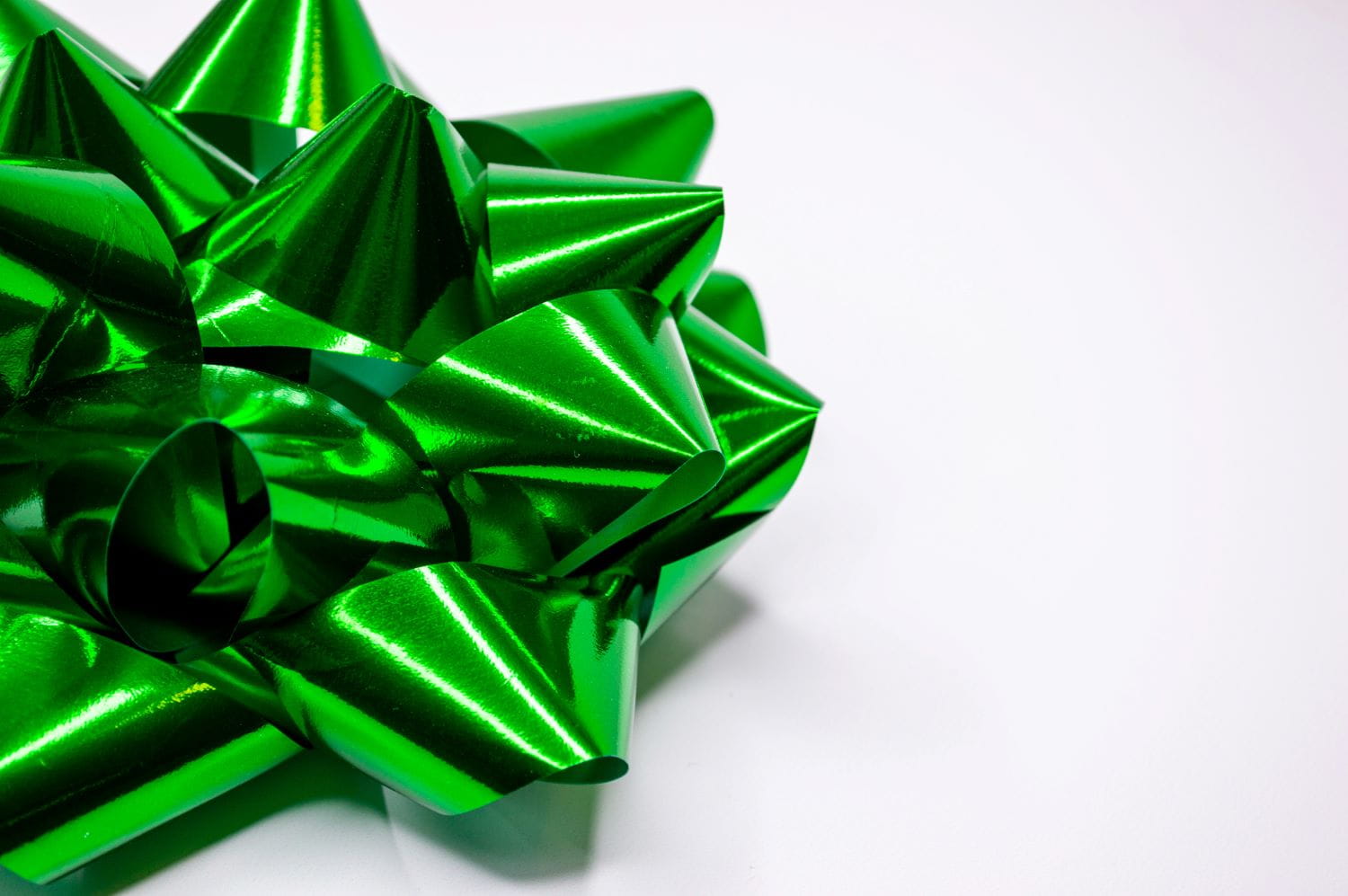 A green metallic gift bow