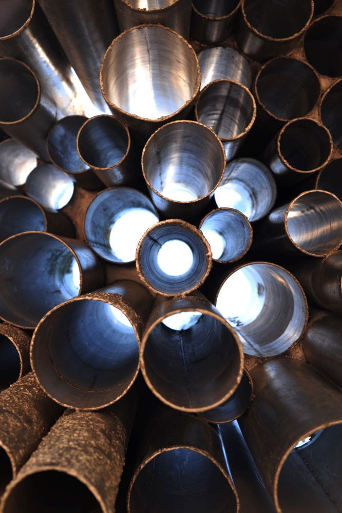 A stack of grey metal pipes