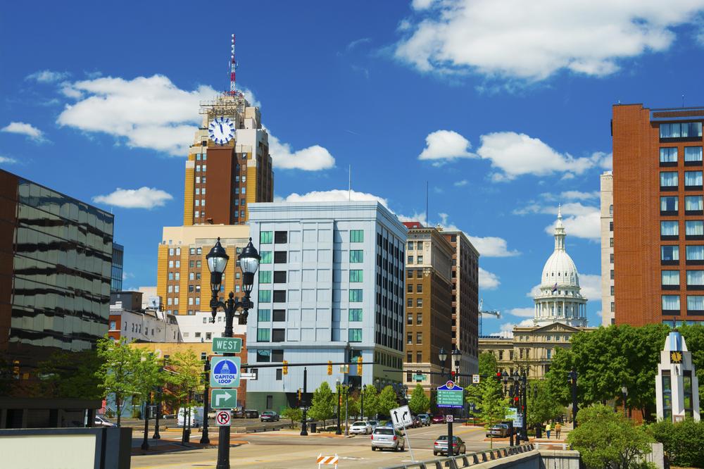 Downtown Lansing on a sunny summer day, looking westward with the State Capitol building in the background