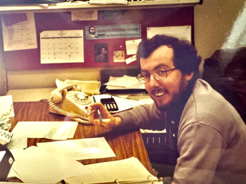 Bob Irvine, seated at a desk, works on rulemaking circa 1982.