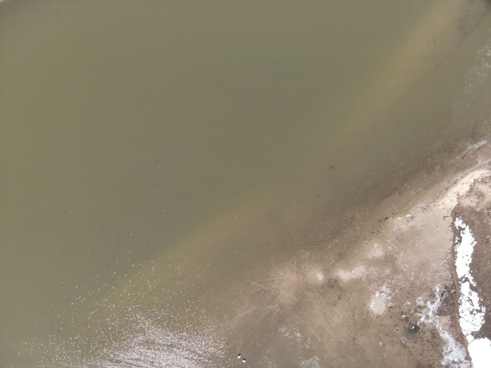 Drone shot of nurdles on the banks of the Kalamazoo River. 
