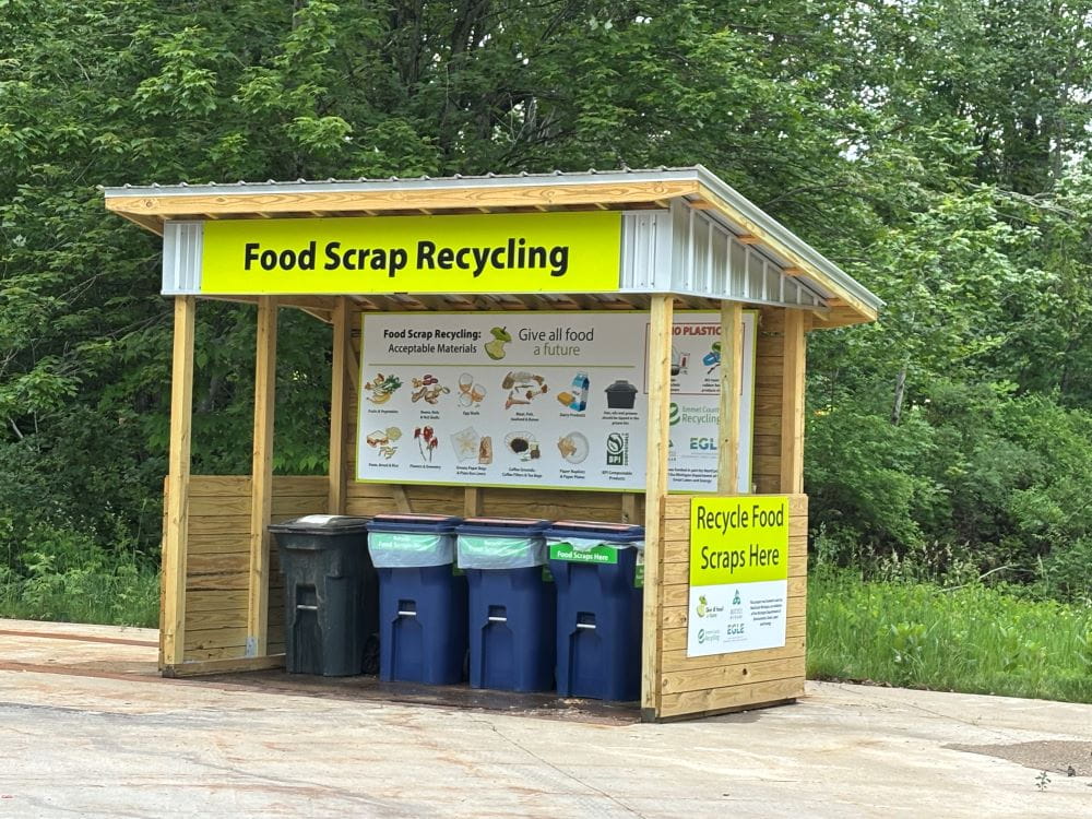 Emmet County’s food scrap drop off site with four containers in a wooden structure.