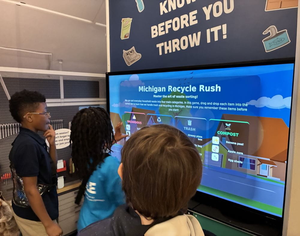 School children play new recycling video game. 