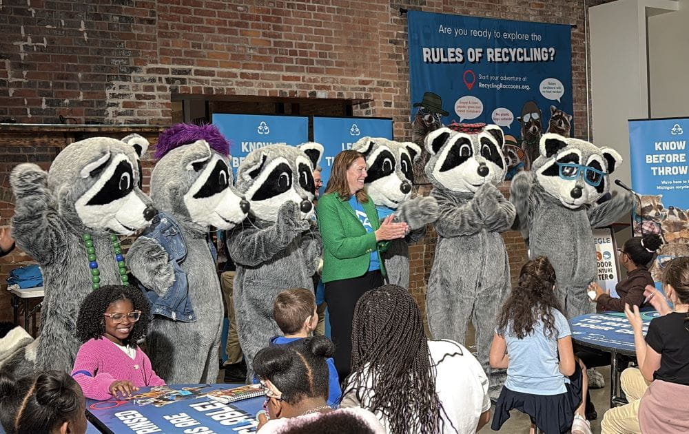 Tracy Kecskemeti, director of EGLE’s Materials Management Division, with the Recycling Raccoons mascot at the Outdoor Adventure Center. 