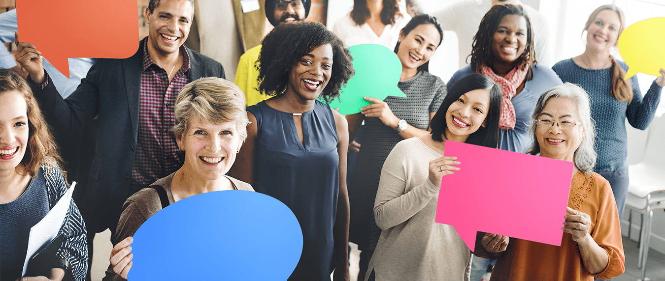 A diverse group of people holding colorful cutouts of speech bubbles