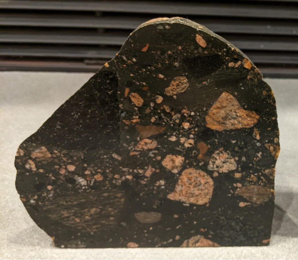A Gowganda tillite rock and a unique glacial erratic rock, both transported by a glacier and deposited in a location different from their origins.