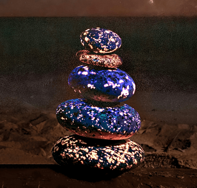 A stack of rocks with glowing golden flecks