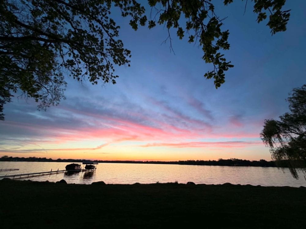 Sunset at Lake Lansing showing docked boats. Credit: Cheri Riemer.