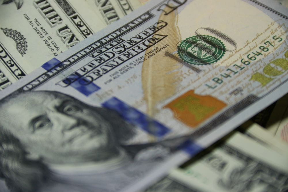 A $100 bill with more behind it