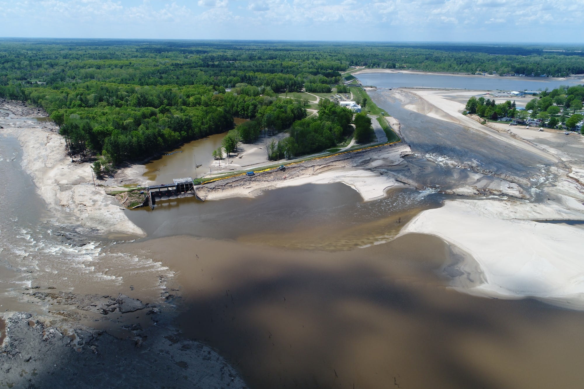 Looking west from the breach along the dam - note diverted Tobacco River and collapsed M-30 bridge in the distance