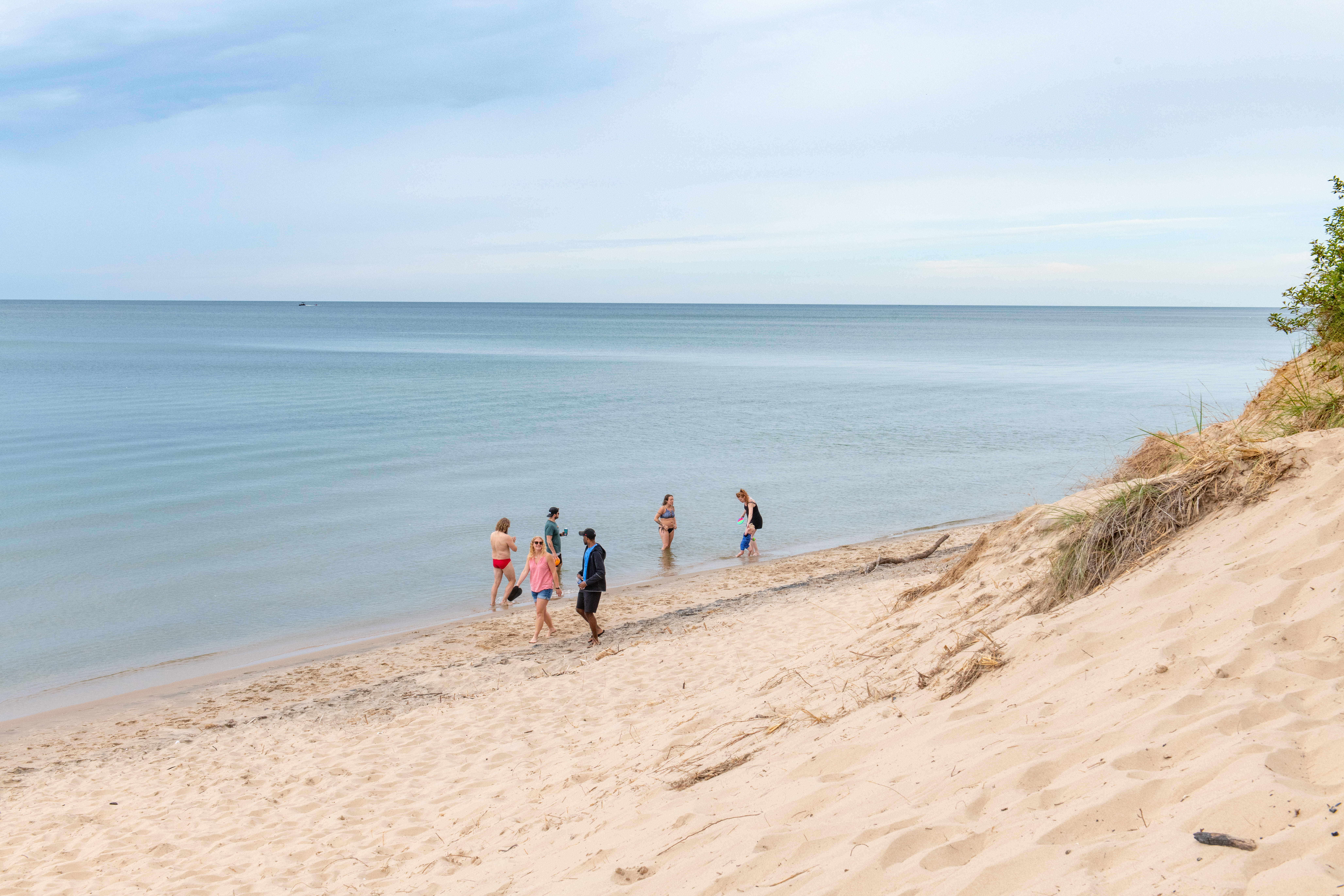 People walking along Saugatuck beach