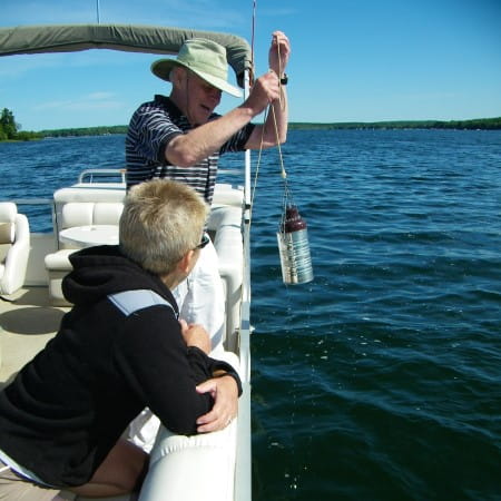 Volunteers Monitor Chlorophyll as they take samples from their lake as part of the CLMP.