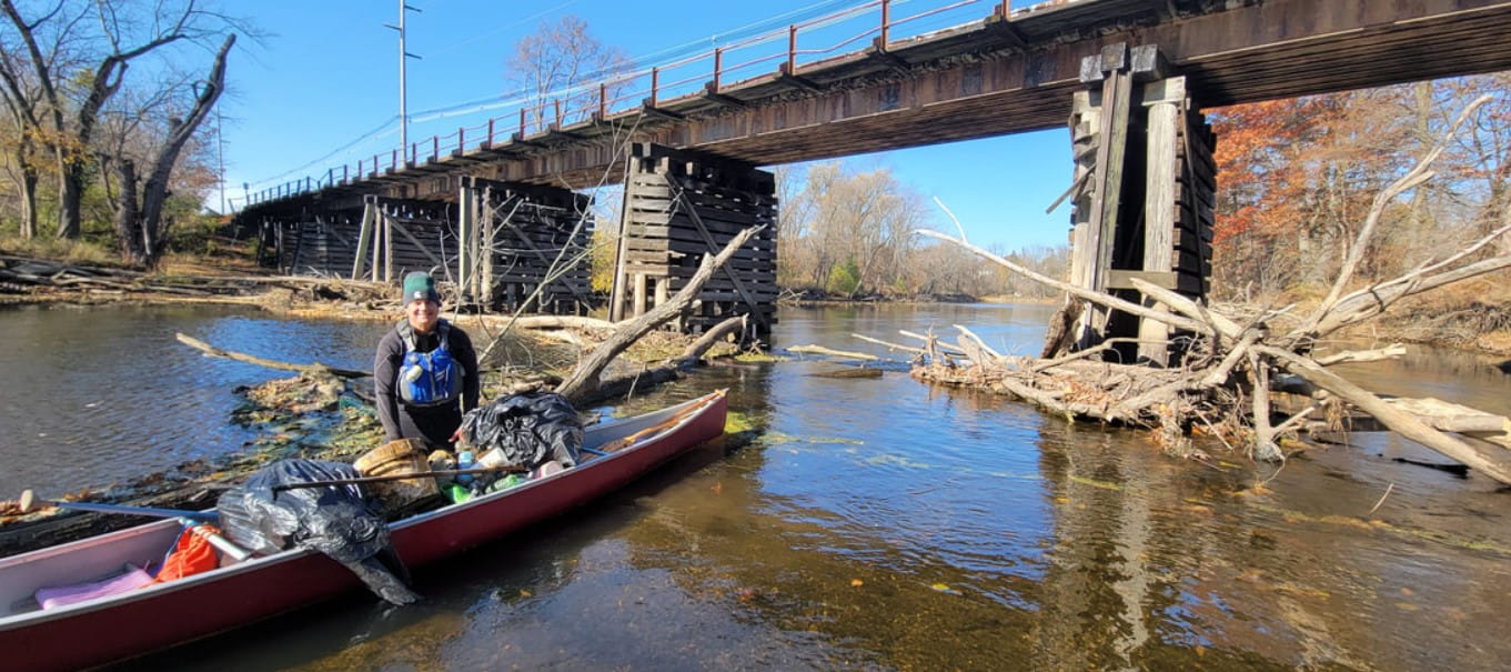 Michigan Waterways Stewards founder, Mike Stout, working on cleaning and clearing a Grand River river-wide obstruction in north Lansing.
