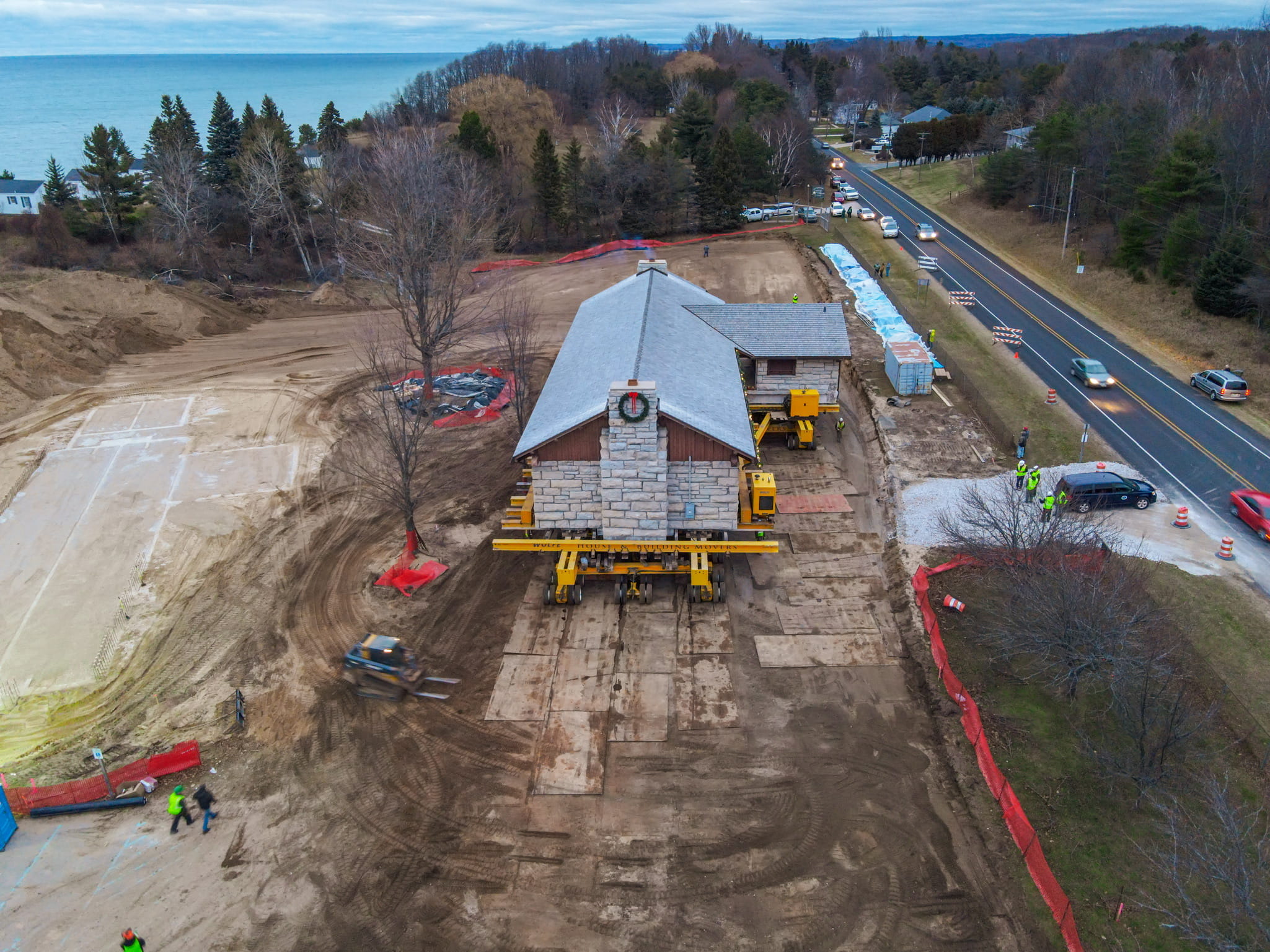 A building being moved away from a high bluff