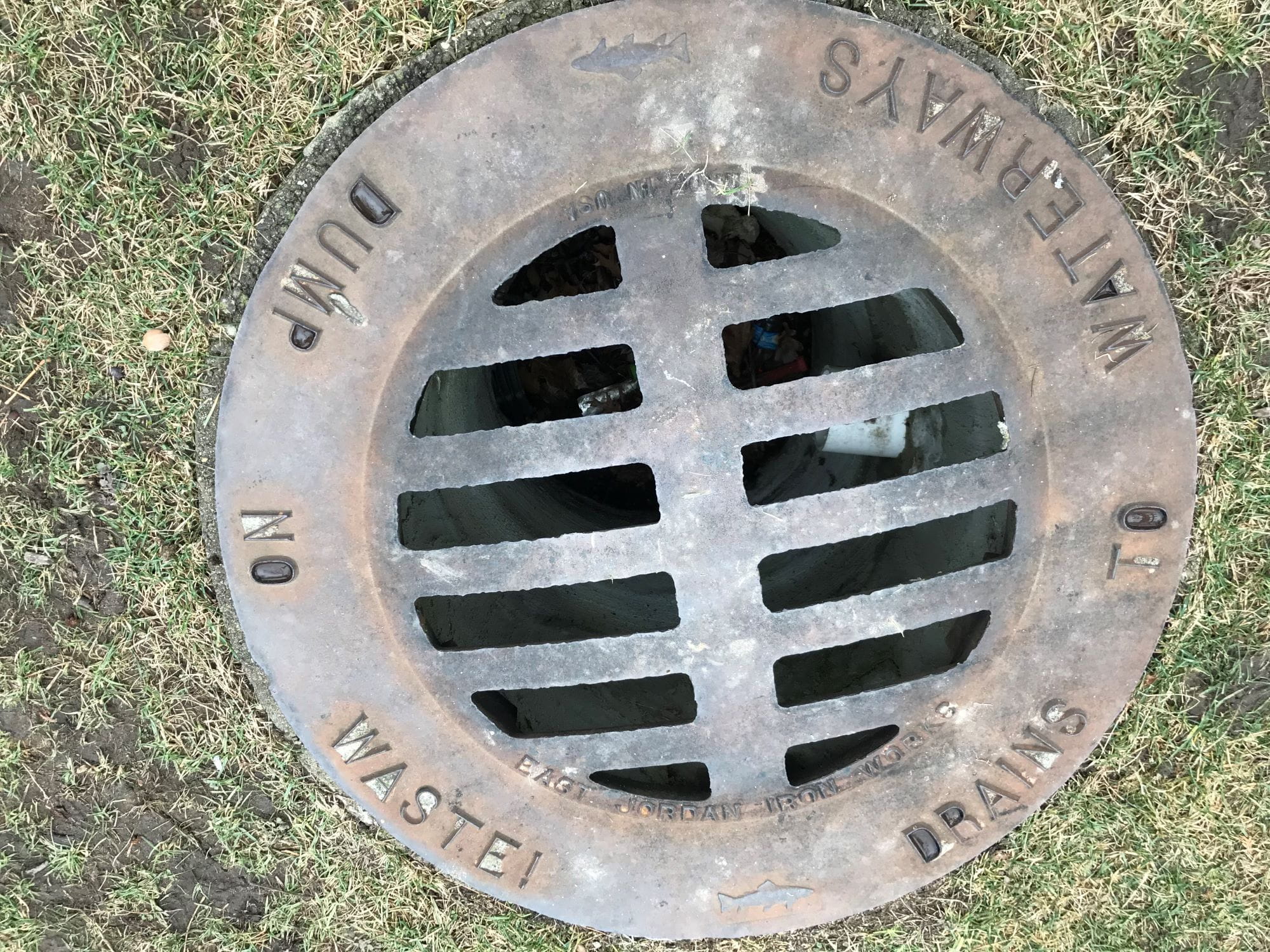 Stormwater drain with "Drains to Waterway. Dump No Waste!" on it. 