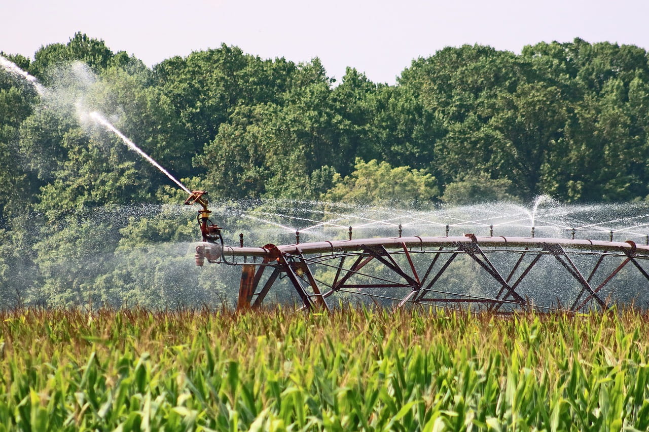 water irrigation system spraying water on a farm field