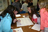 Young students analyzing specimen for experiment