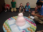 Students watching cylinder overflow