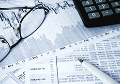 Glasses and calculator on top of financial documents