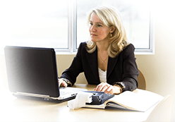 Woman using a computer and adding machine