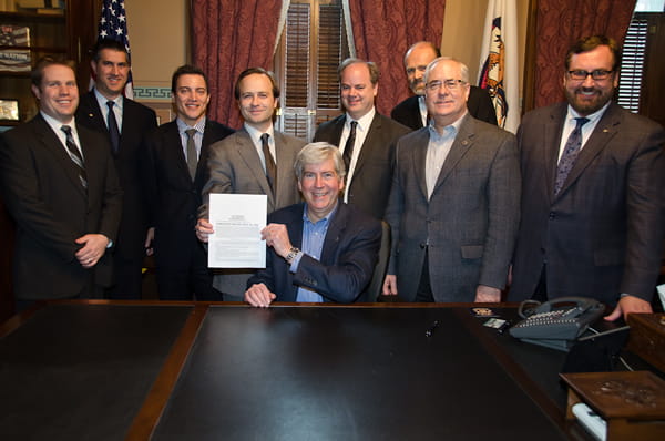 Gov. Rick Snyder, Lt. Gov. Brian Calley and other advocates holding signed legislation Gov. Rick Snyder, Lt. Gov. Brian Calley and other advocates holding signed legislation