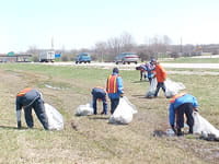 Clean-up crews along the side of the road
