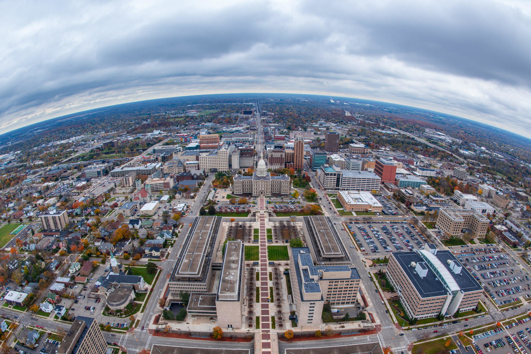 Aerial photo of downtown Lansing. Features the Michigan State Capitol and area buildings.