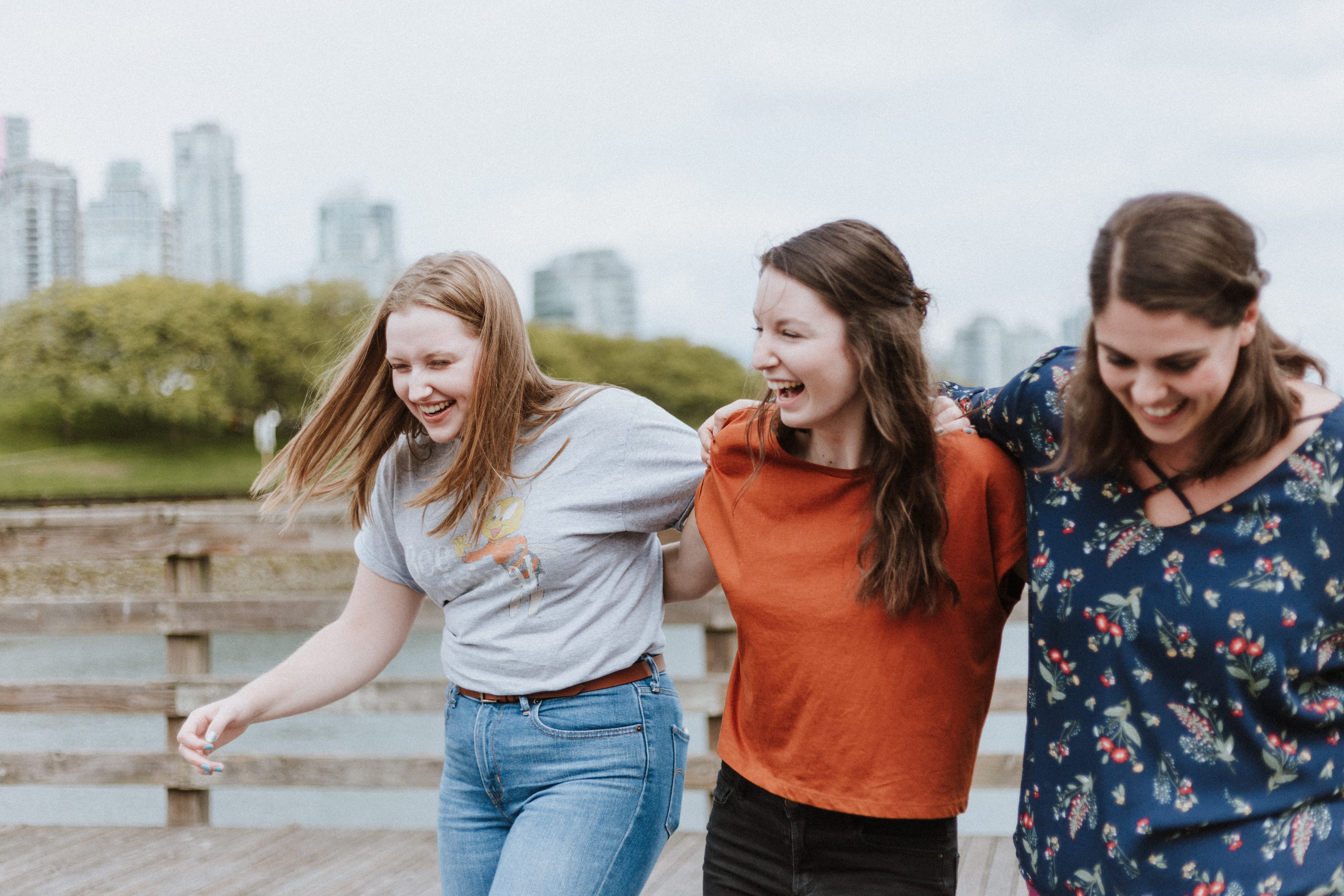 Photo of three teens walking together and smiling.