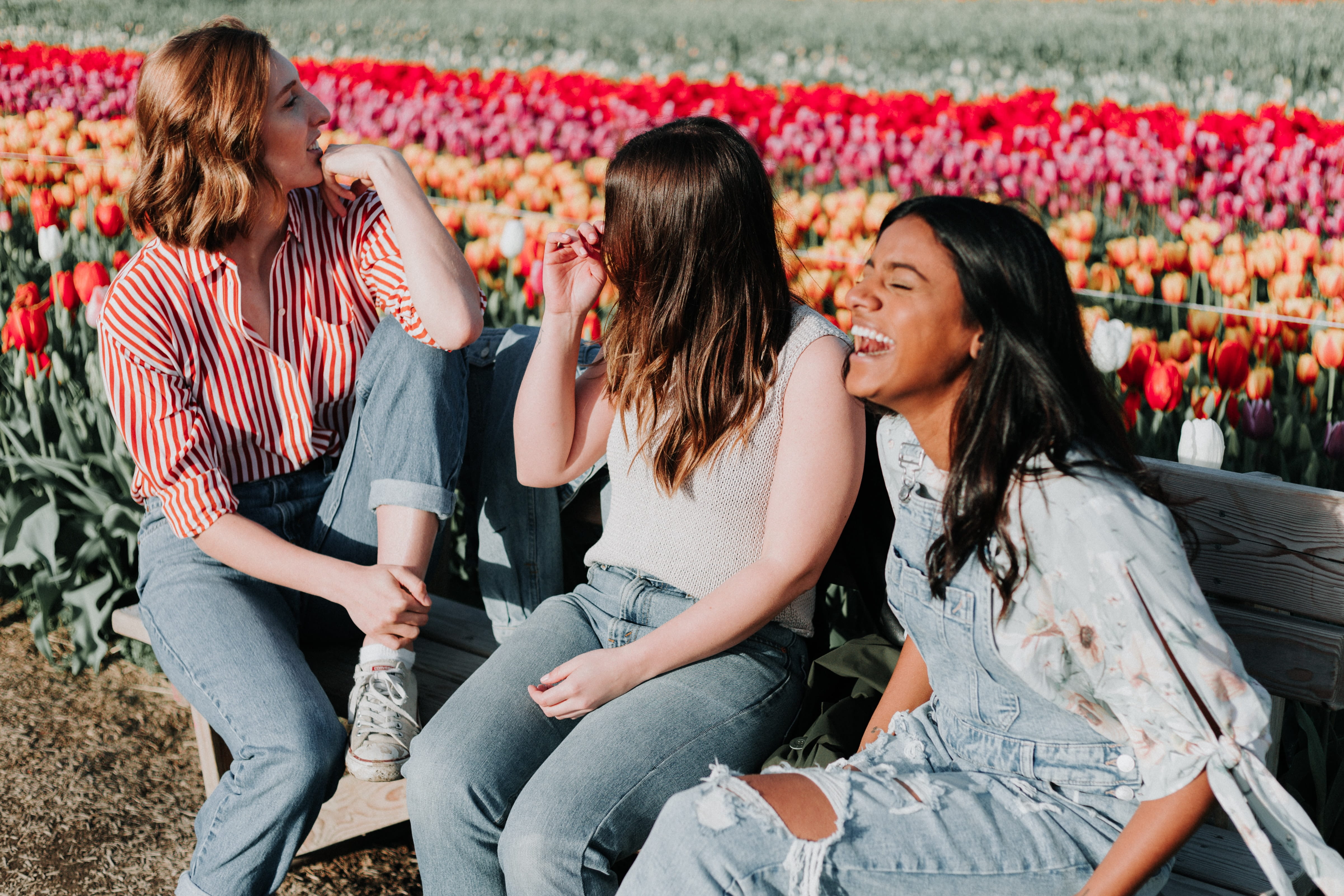 Photo of three teens smiling.