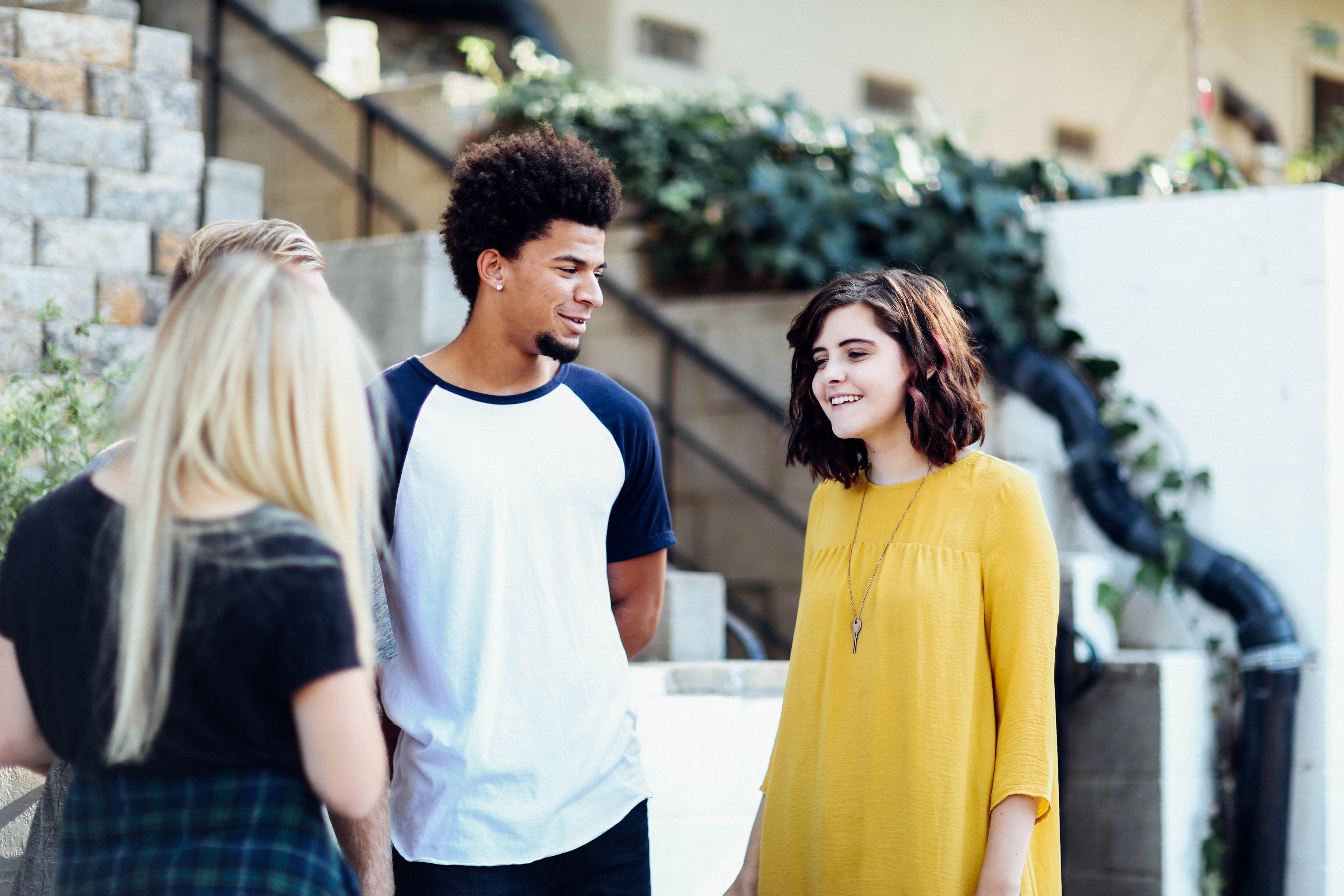 Photo of three teens talking.