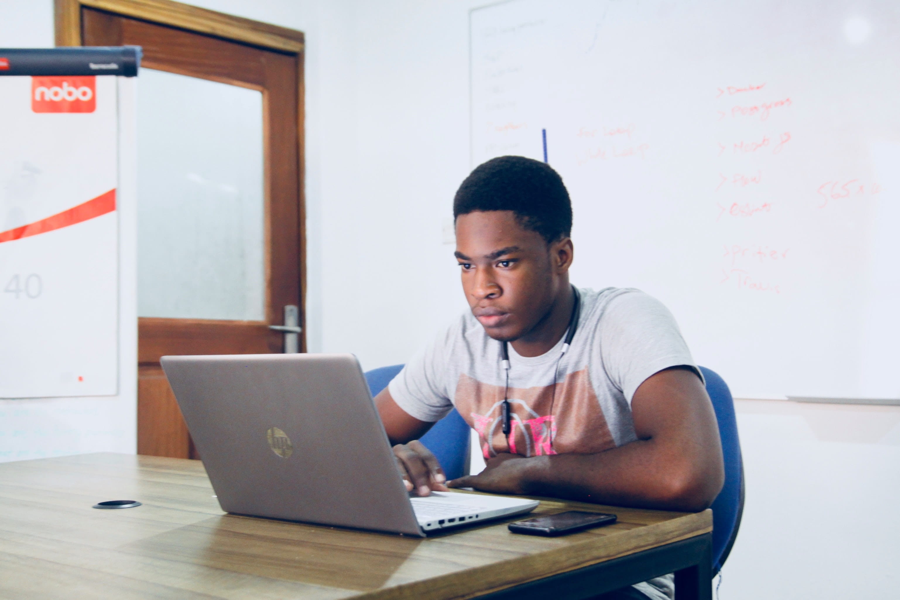 Photo of a man sitting at a computer. 