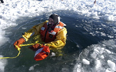 a man getting rescued from a hole in the ice