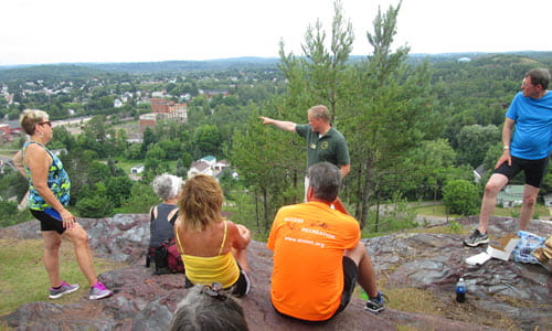 Historian/tour guide Troy Henderson speaks to cyclists at Jasper Knob, which overlooks Ishpeming Historian/tour guide Troy Henderson speaks to cyclists at Jasper Knob, which overlooks Ishpeming