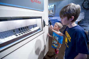 Boy explores an exhibit at the Michigan Iron Industry Museum Boy explores an exhibit at the Michigan Iron Industry Museum