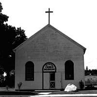 The front façade of the Saint Igance Mission, Saint Ignace, Michigan. A cross projects from the roof The front façade of the Saint Igance Mission, Saint Ignace, Michigan. A cross projects from the roof