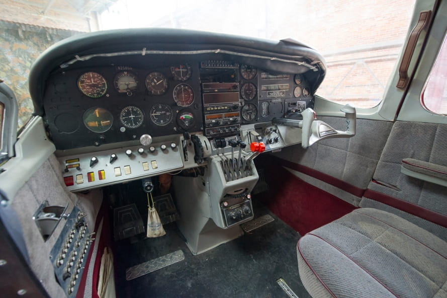 inside view of Outdoor Adventure Center airplane, with instrument panel, controls, pilot seat inside view of Outdoor Adventure Center airplane, with instrument panel, controls, pilot seat