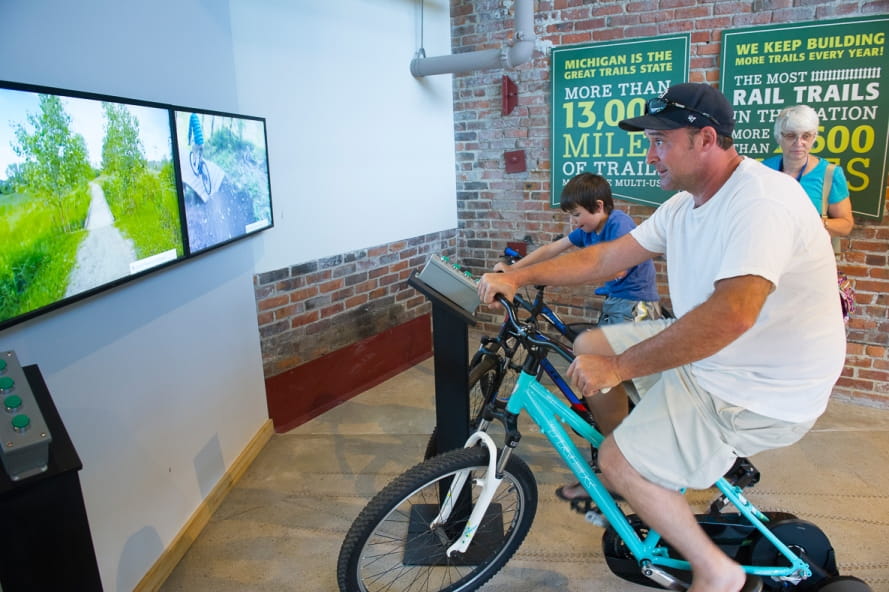 man and boy on OAC mountain bike simulators