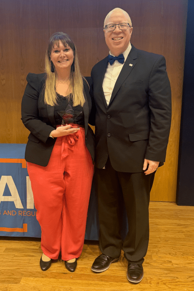 Director Brown and Amber Daniels Posing with Award