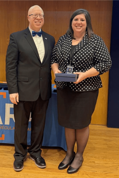 Director Brown and Andrea Moore Posing with Award