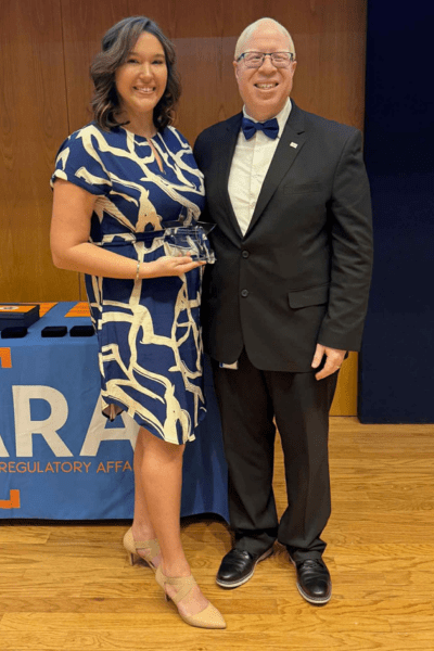 Director Brown and Casey McGuire Posing with Award