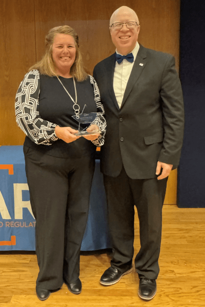 Director Brown and Christina Forist Posing with Award