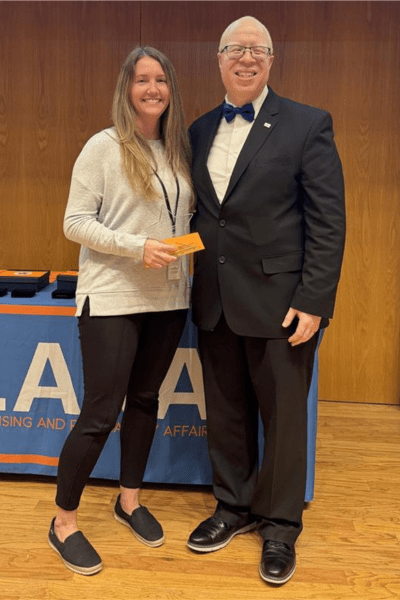 Director Brown and Erin Wingeier Posing with Award