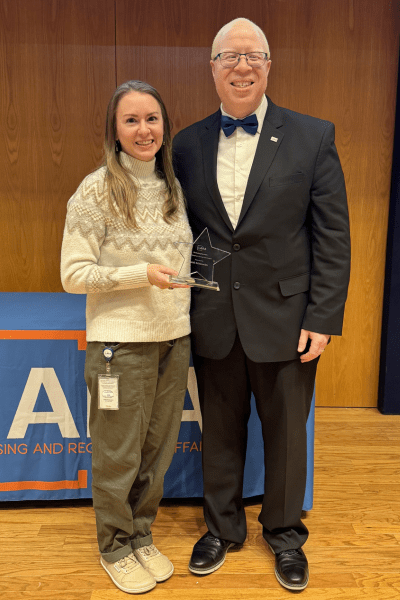 Director Brown and Sarah Eckenwiler Posing with Award