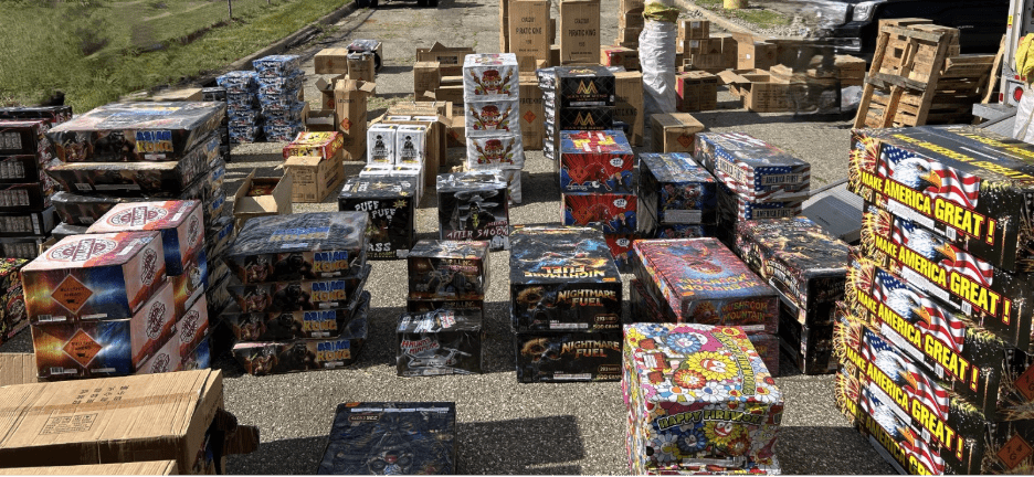 Boxes of fireworks stacked on pavement