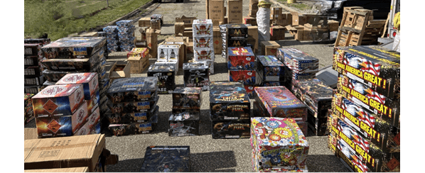 Boxes of fireworks stacked on pavement