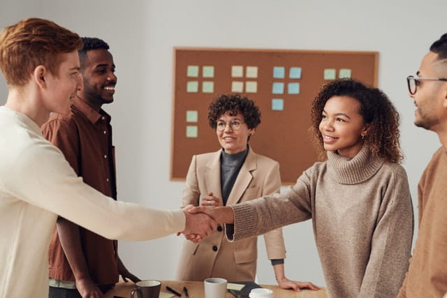 Group of Business Professionals Two Shaking Hands