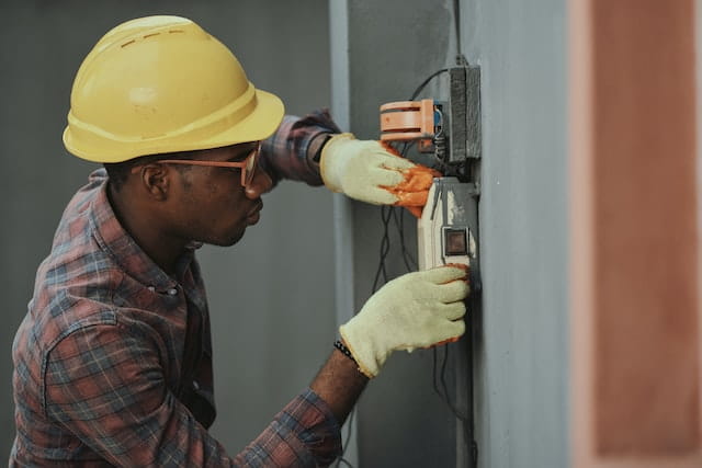Electrician performing work on an electrical box