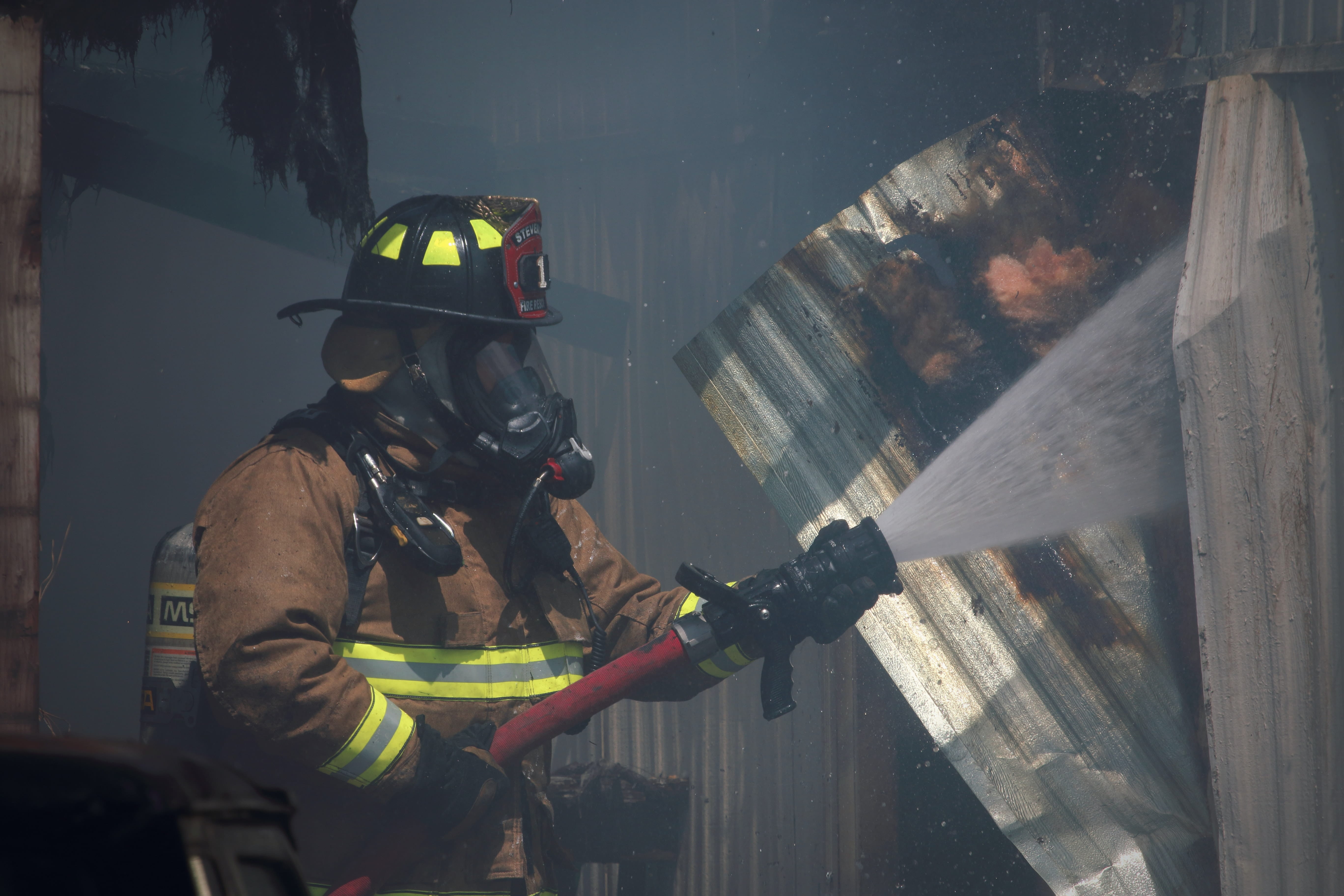 fire fighter extinguishing a building fire