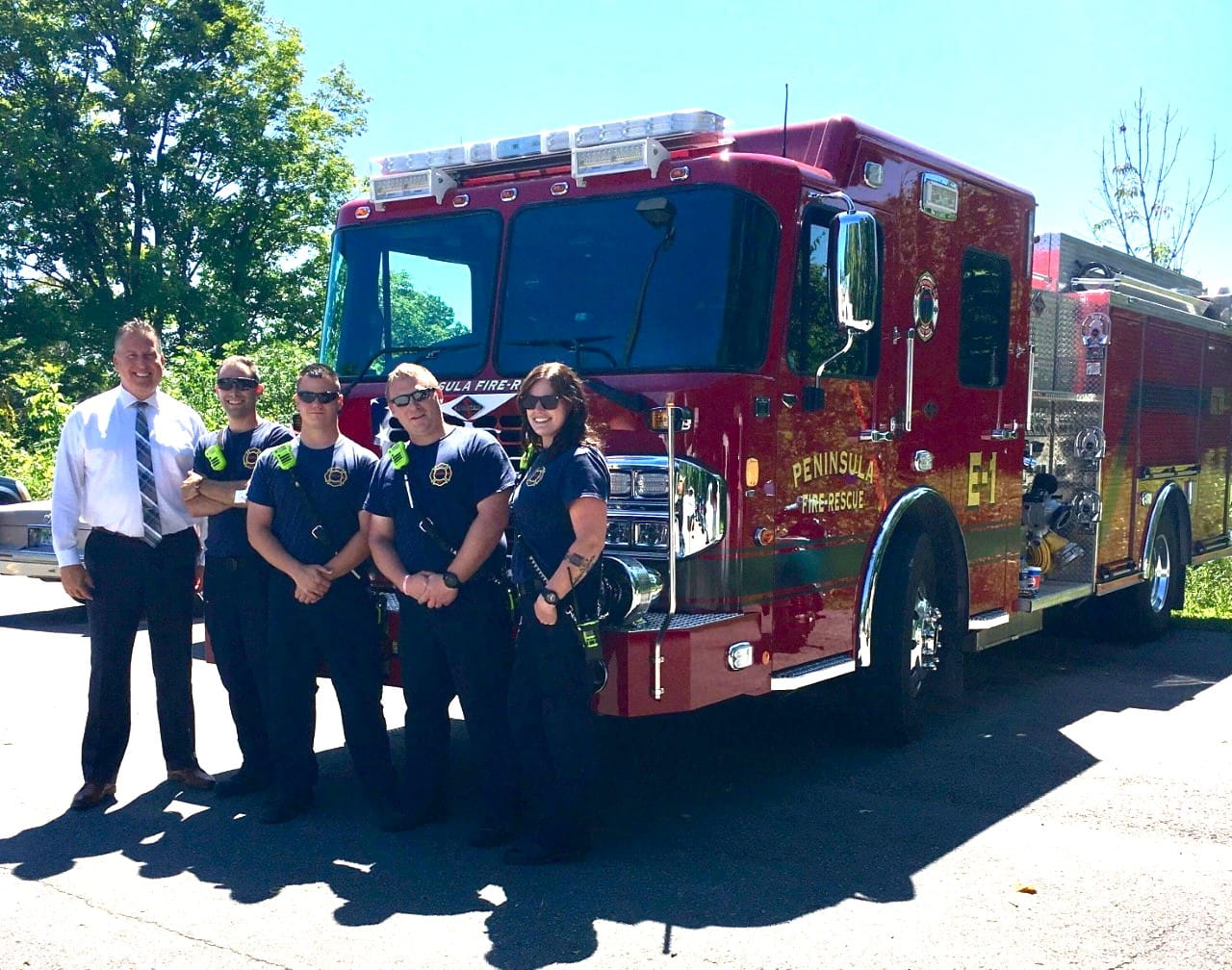 Fire Marshall and staff posing in front of truck