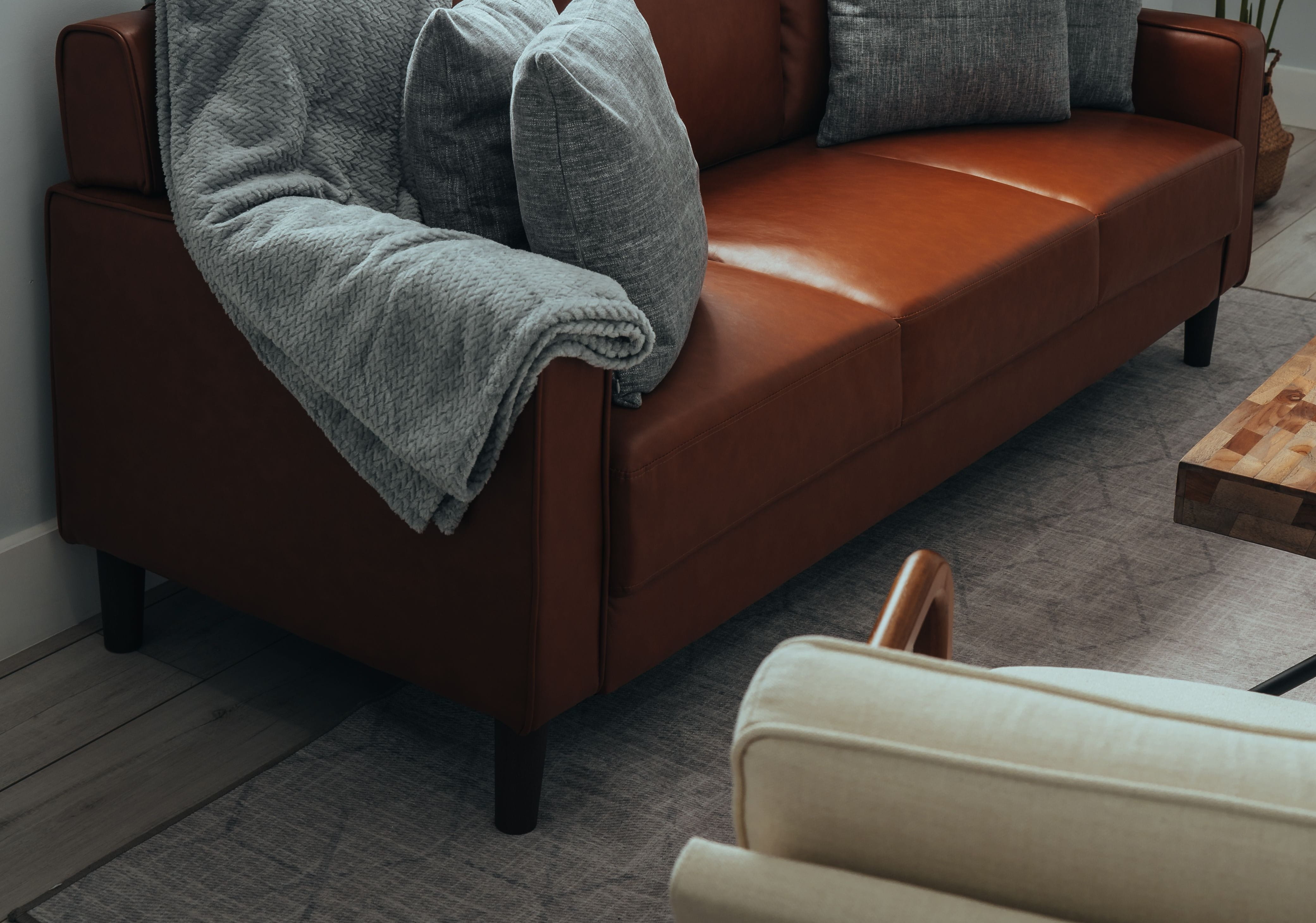 Chair facing a brown leather couch